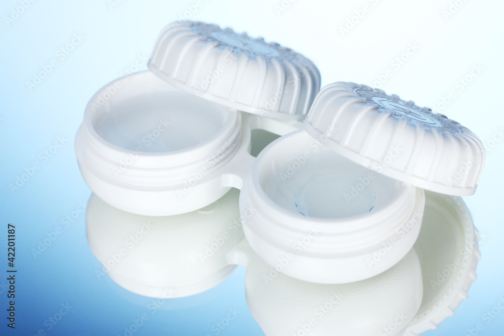 containers for contact lenses on blue background containers for contact lenses on blue background