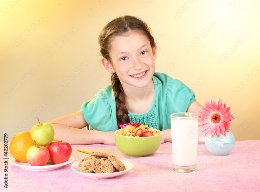 little beautiful girl have a breakfast on beige background little beautiful girl have a breakfast on beige background