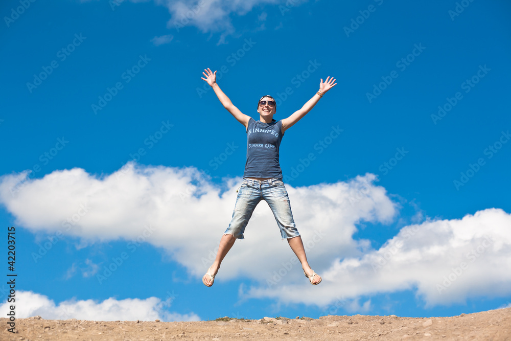 jumping girl with hands up against