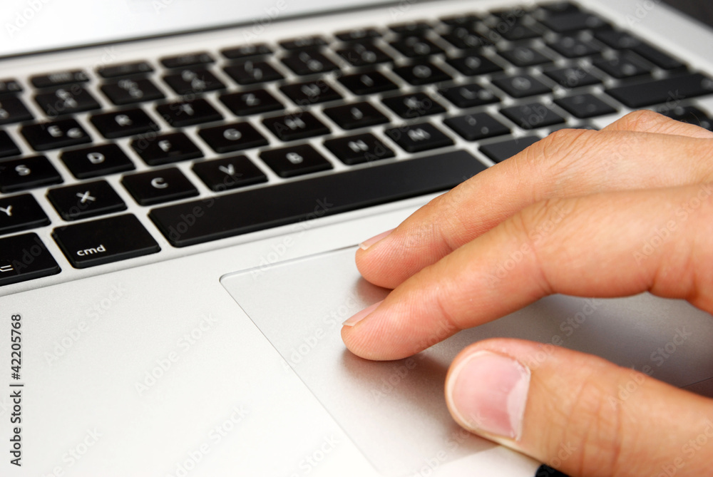 male hand with touchpad on laptop