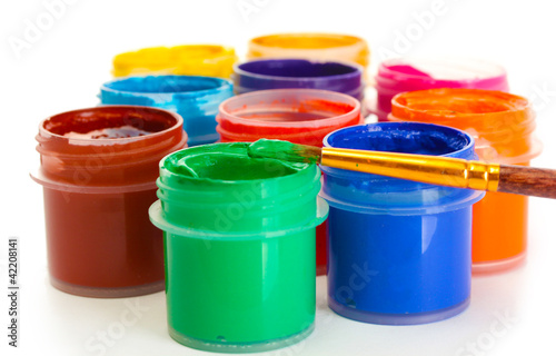 jars with multicolored gouache on white background close-up