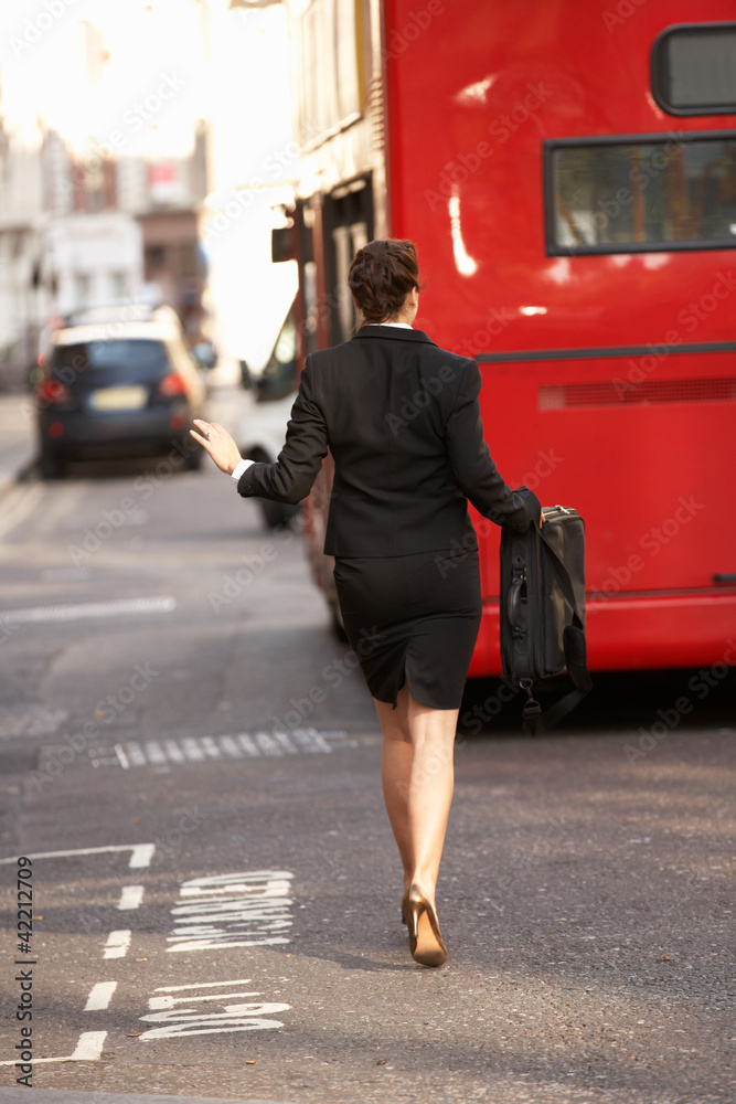 Fototapeta premium Businesswoman running for bus