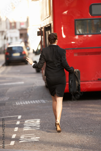 Businesswoman running for bus © Monkey Business