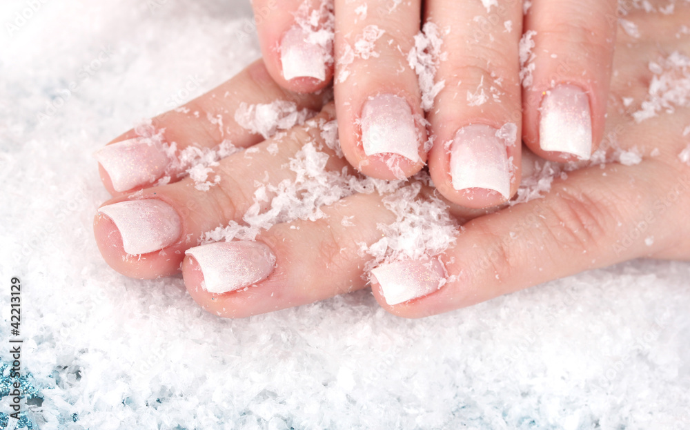 Fototapeta premium beautiful hands with snow closeup