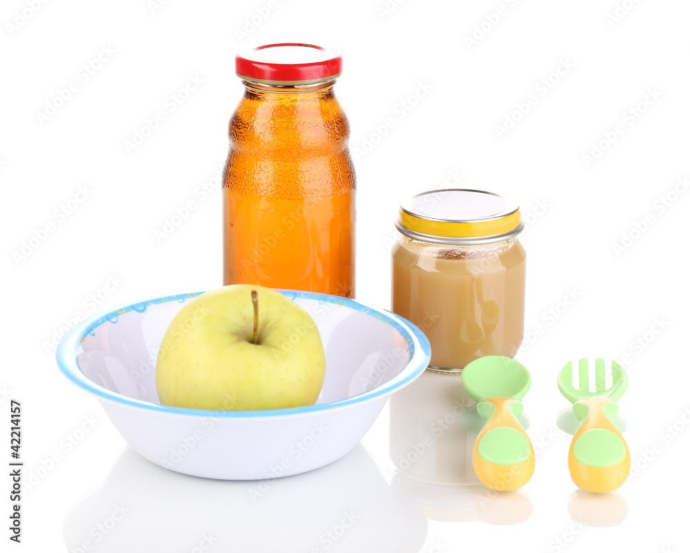 Jar of baby puree and juice with plate, spoon and fork isolated Jar of baby puree and juice with plate, spoon and fork isolated