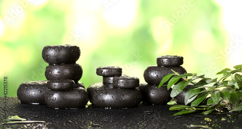 Composition of spa stones on bright green background
