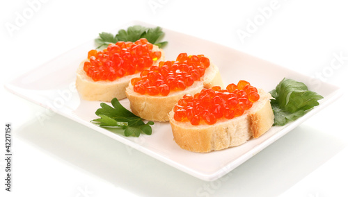Red caviar on bread on white plate isolated on white