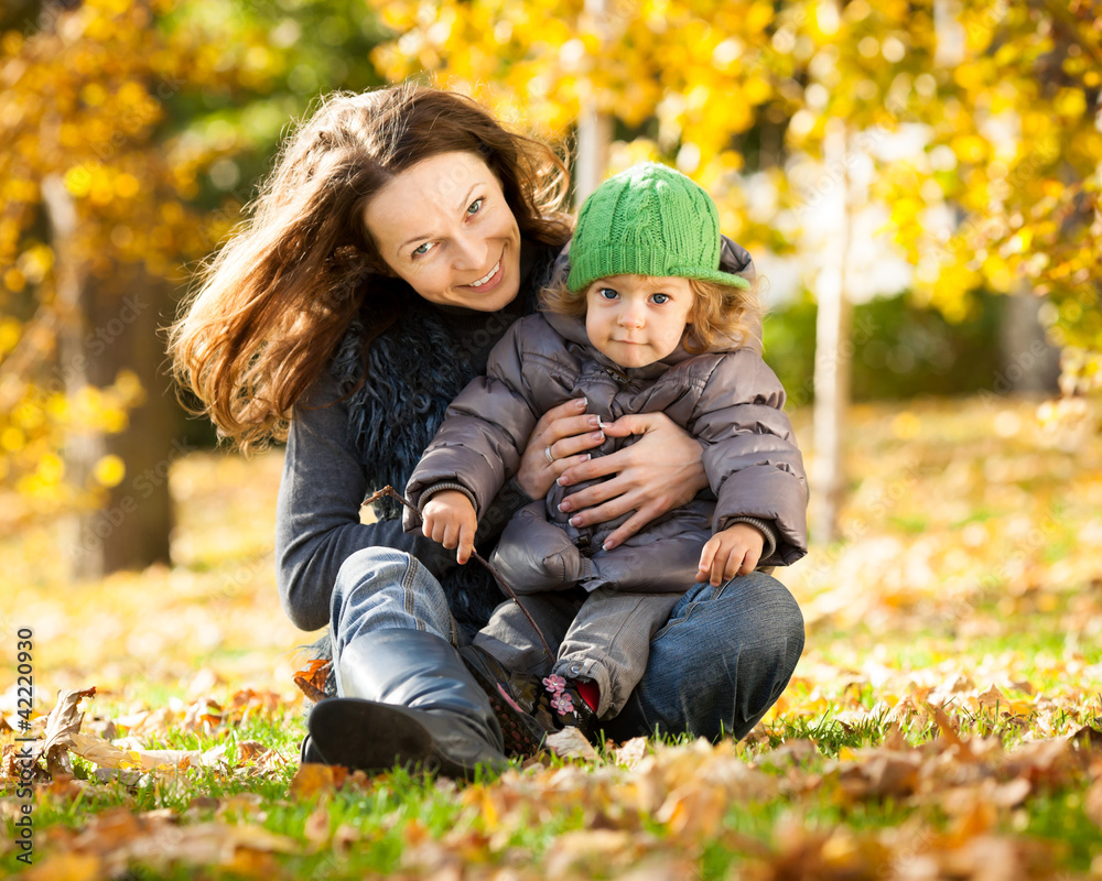 Woman with child having fun in autumn Woman with child having fun in autumn