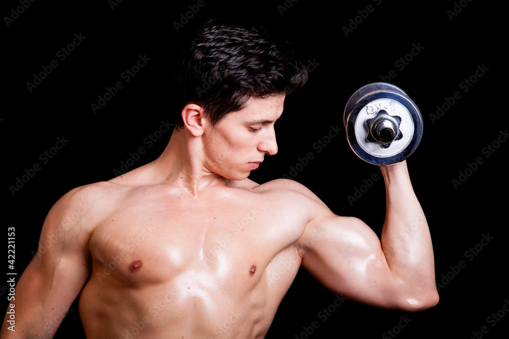 Young muscular man lifting weights on black background Young muscular man lifting weights on black background