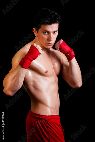 Young Boxer fighter over black background © cristovao31