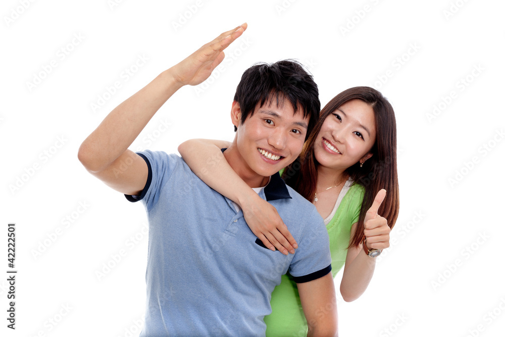 Young smiling people with thumbs up gesture on white background Young smiling people with thumbs up gesture on white background