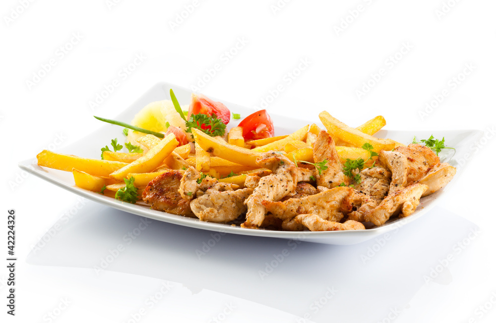 Grilled meat French fries and vegetables on white background Grilled meat French fries and vegetables on white background
