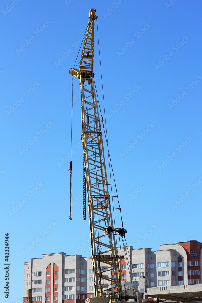 yellow crane and blue sky on building site yellow crane and blue sky on building site