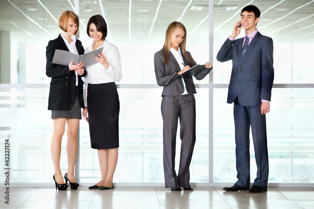 Business people discussing in a office corridor Business people discussing in a office corridor