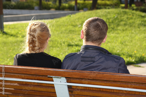 Man and woman sitting in park