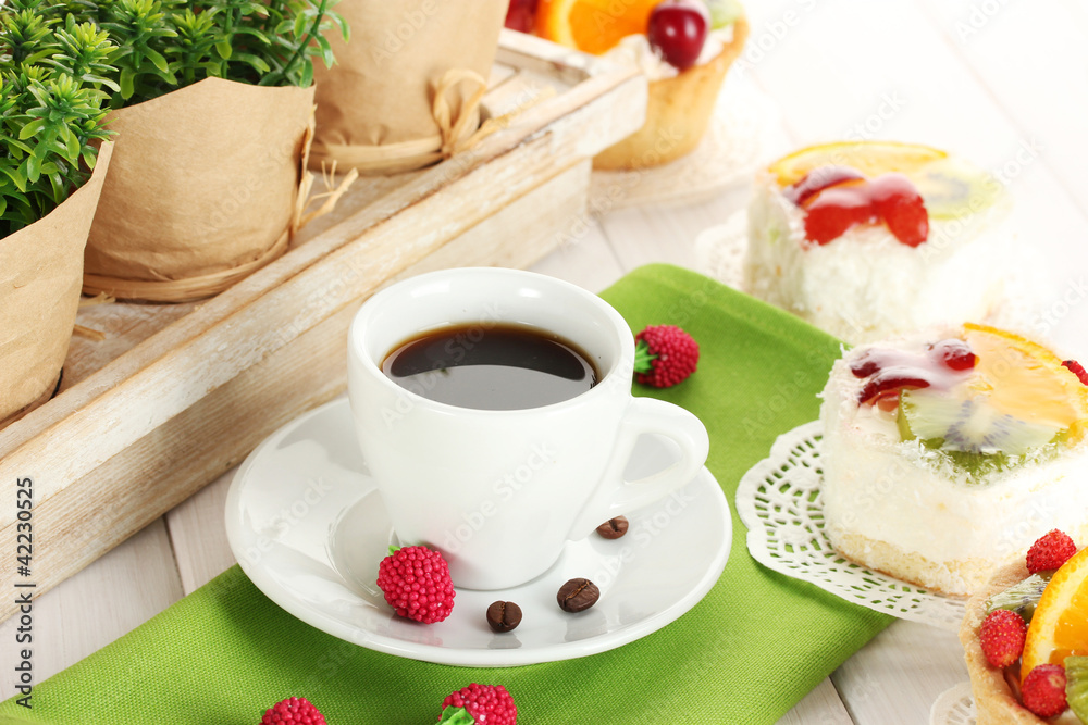 cup of coffee and sweet cakes with fruits on wooden table cup of coffee and sweet cakes with fruits on wooden table