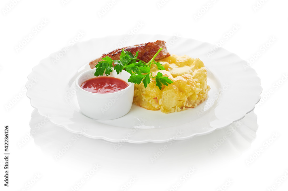 Grilled meat with trimmings isolated on a white background Grilled meat with trimmings isolated on a white background