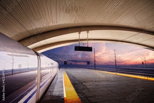 Obraz na plátně train stop at railway station with sunset