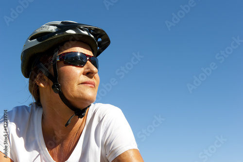 Portrait confident mature bike riding woman