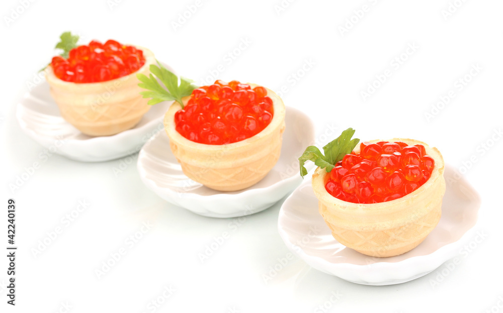 Red caviar in tartlets on little white saucers isolated on Red caviar in tartlets on little white saucers isolated on