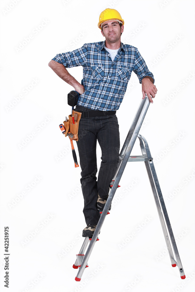An handyman on a ladder. An handyman on a ladder.