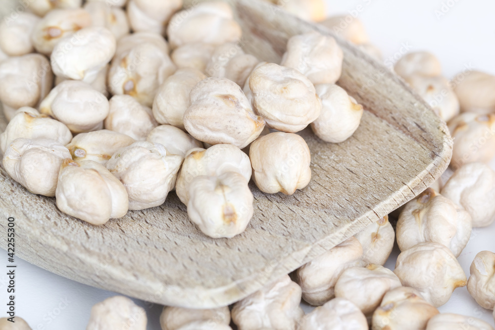 chickpeas on wooden spoon and white background chickpeas on wooden spoon and white background