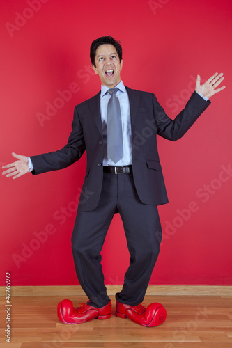 Businessman with clown shoes photo