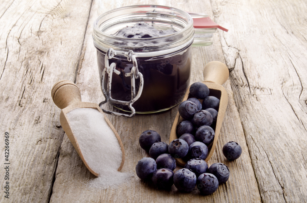 freshly picked blueberries with a wooden spoon freshly picked blueberries with a wooden spoon