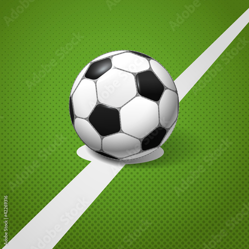 Soccer ball lying on the center of the game field