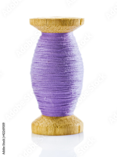 wooden spool with thread