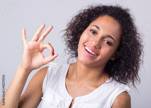happy young woman hand gesture ok sign  photo