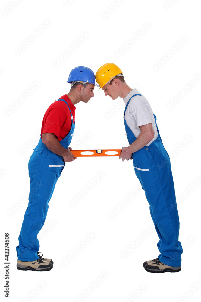two craftsmen holding a level two craftsmen holding a level