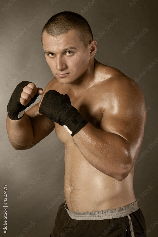 Young Boxer fighter over black