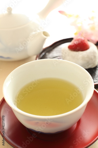 Japanese green tea with wagashi on background