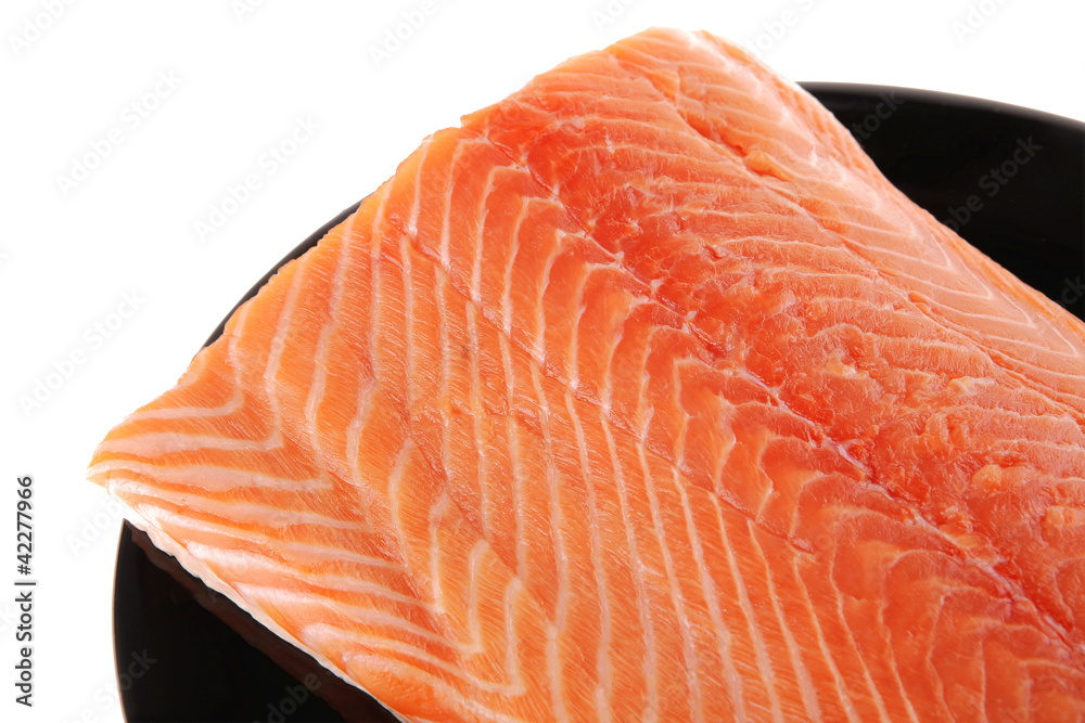 big salmon chunk on black plate