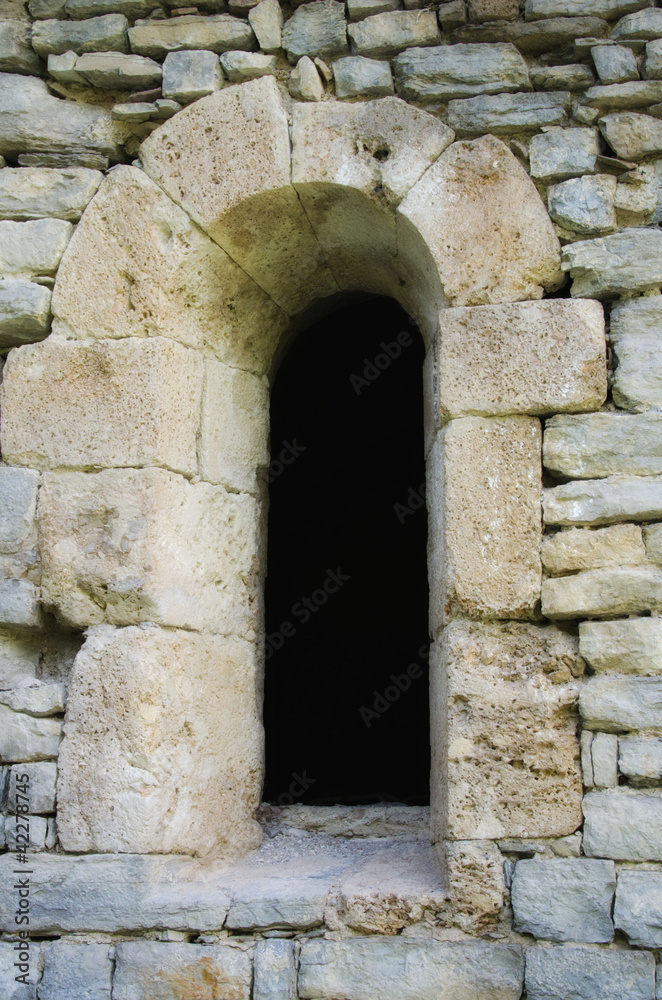 window in the old stone wall