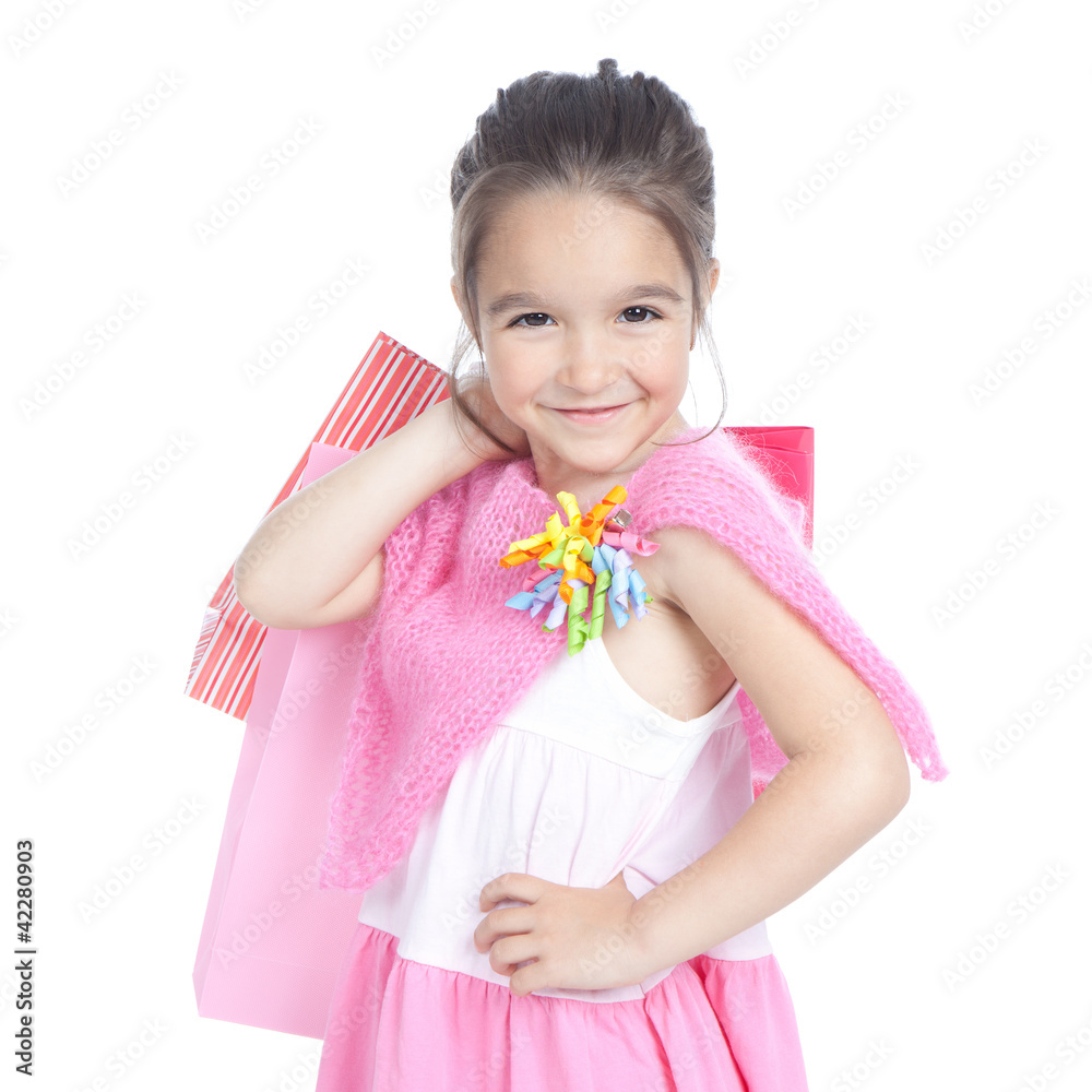 Little smiling girl with shopping bags over white Little smiling girl with shopping bags over white