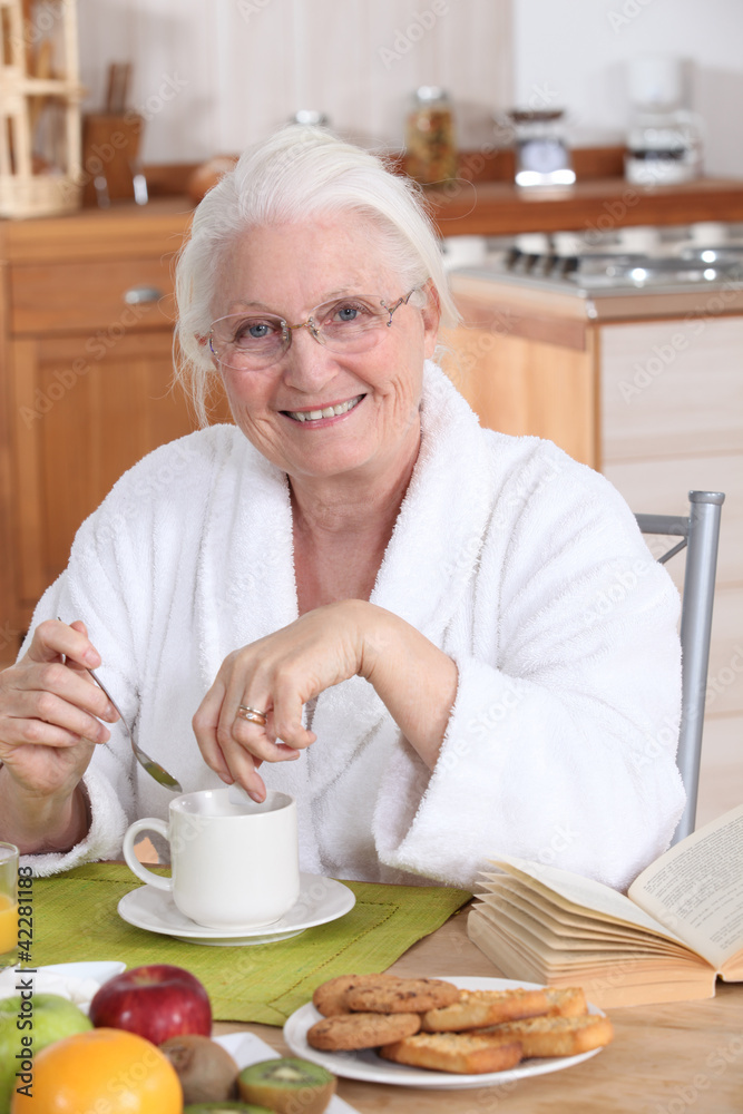 granny in the kitchen having breakfast granny in the kitchen having breakfast