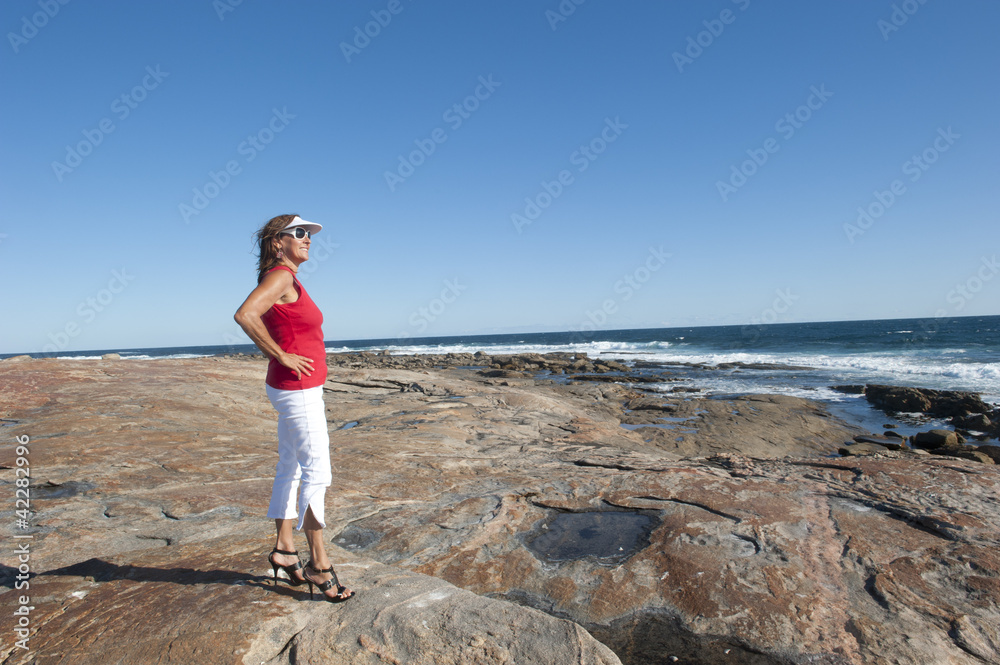Relaxed pretty woman in high heels at ocean