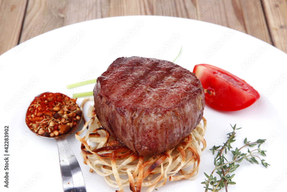 grilled beef fillet pieces on noodles with tomatoes and dry spic grilled beef fillet pieces on noodles with tomatoes and dry spic