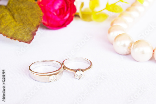 Diamond rings with Pearl on roses background,wedding concept