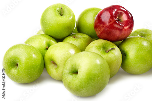 red apple between green apples