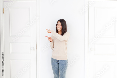 a young asian woman and two doors