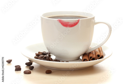 cup of coffee with lipstick mark beans and cinnamon sticks