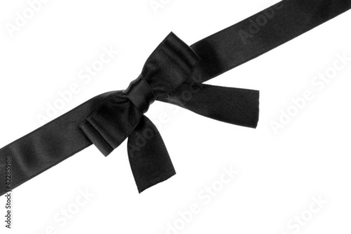 black bow on ribbon isolated on white.