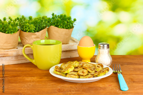 Fried zucchini with eggs and coffee for breakfast