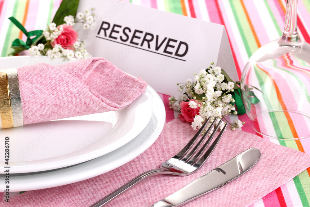 Table setting with reserved card in restaurant Table setting with reserved card in restaurant