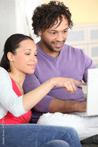 Couple happily browsing the internet