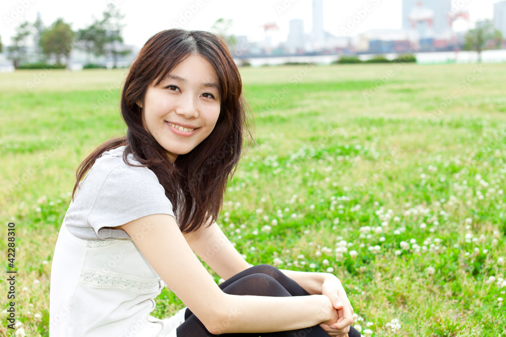 Beautiful young woman in the park. Portrait of asian.