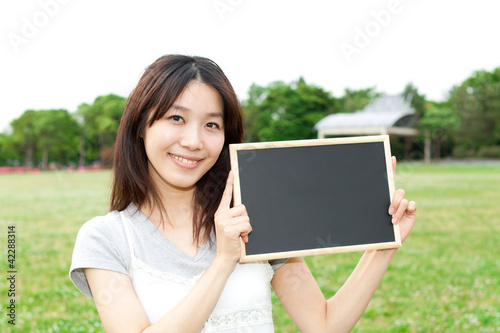 Beautiful young woman with message board. Portrait of asian.
